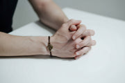 Close-up of a person's wrist wearing a bracelet with a circular design.