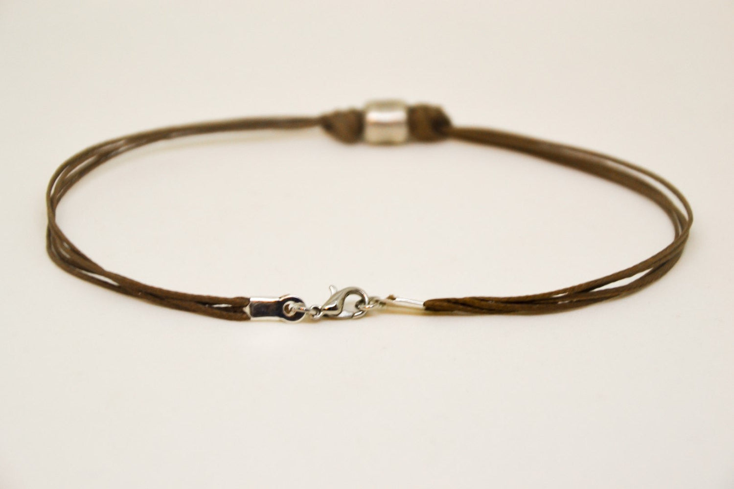 Men's anklet with a silver tube charm and a brown cord - shani-adi-jewerly