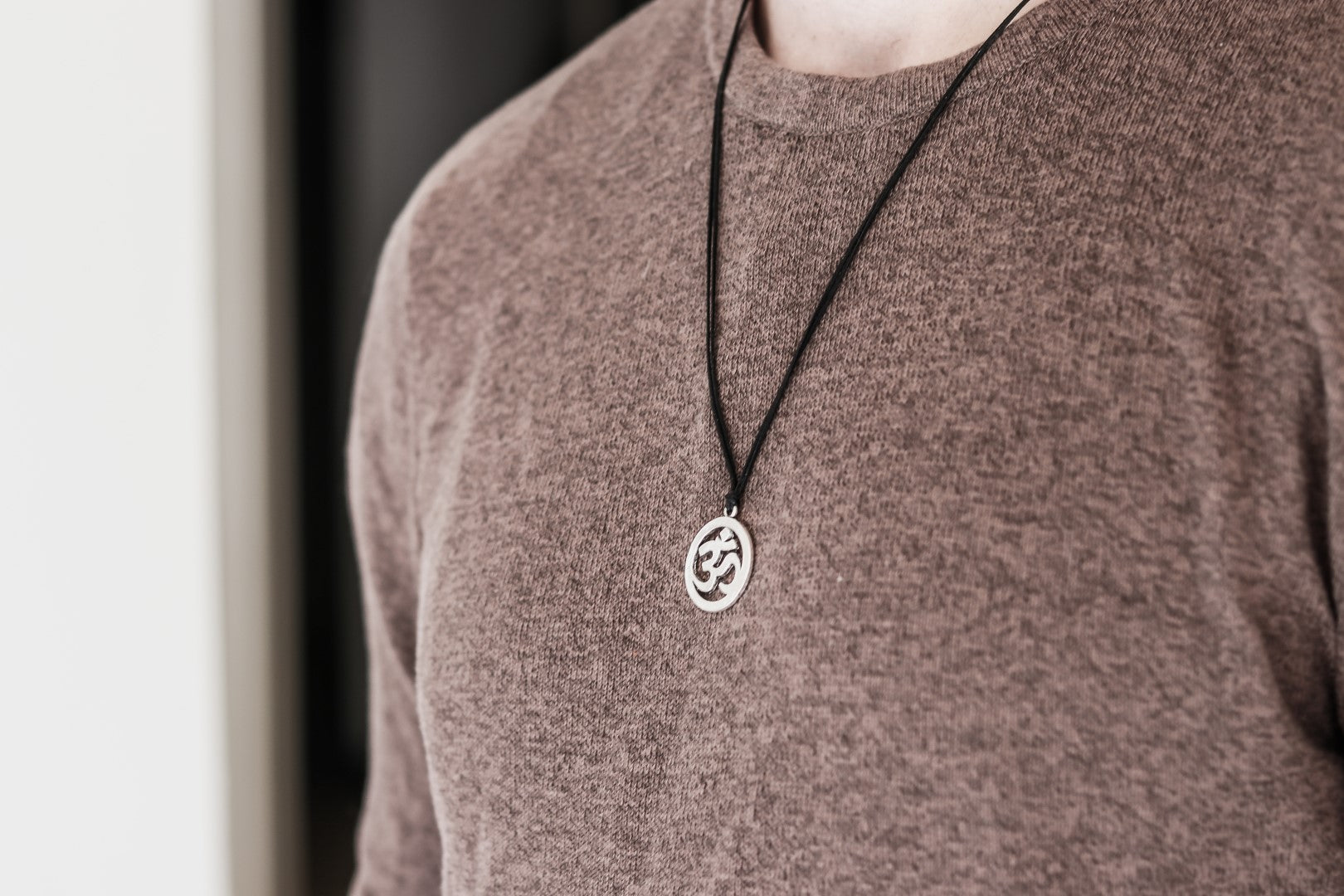 Men's necklace with a silver Om pendant, black cord, yoga jewelry for