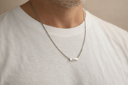 Person wearing a silver necklace with a name pendant on a plain background Personalized Gift Name Necklace For Men Waterproof Stainless Steel Chain Silver Custom Engraved Jewelry Father's Day Gift