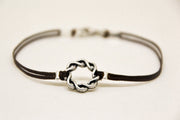 Karma bracelet for men with a silver braided circle charm, brown cord