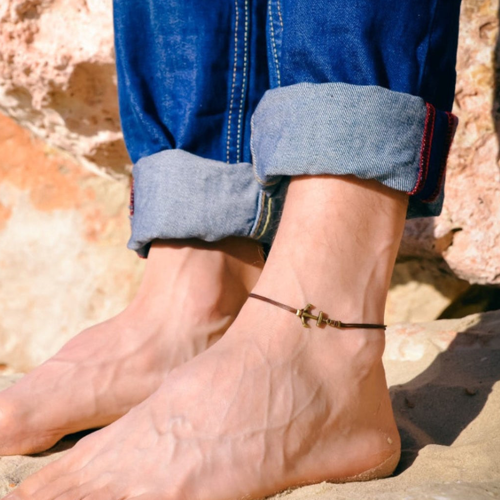 Person wearing a anklet on a rocky surface
