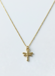 Gold bracelet with a dragonfly charm on a white background