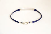 Navy blue bracelet with a silver clasp on a white background