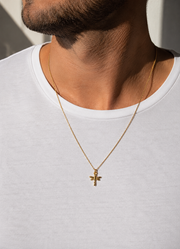 Gold necklace with a dragonfly pendant on a white background