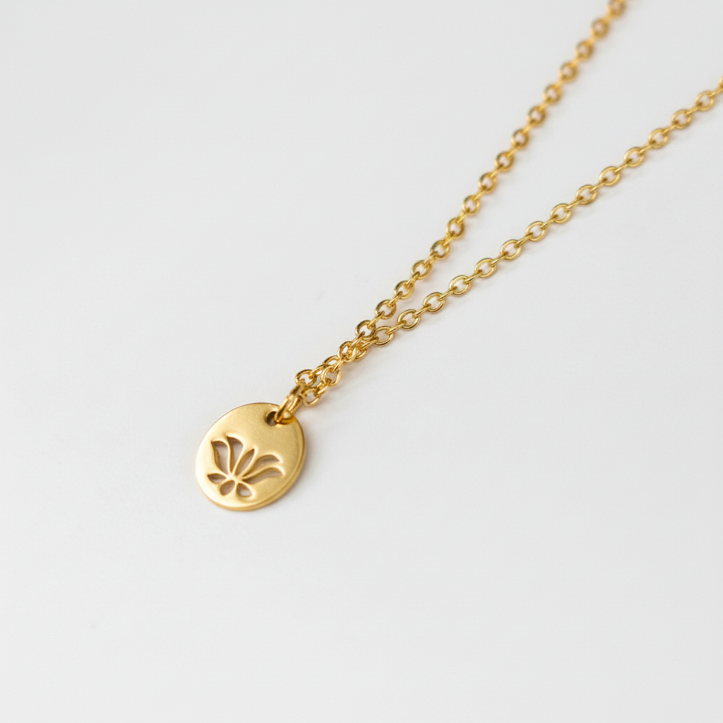 gold necklace with a lotus pendant