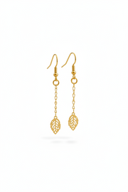 Gold leaf-shaped earrings on a white background