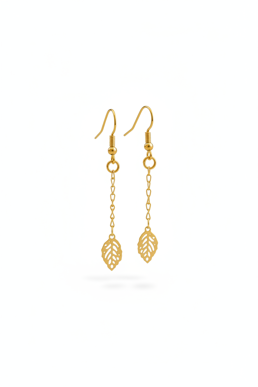 Gold leaf-shaped earrings on a white background