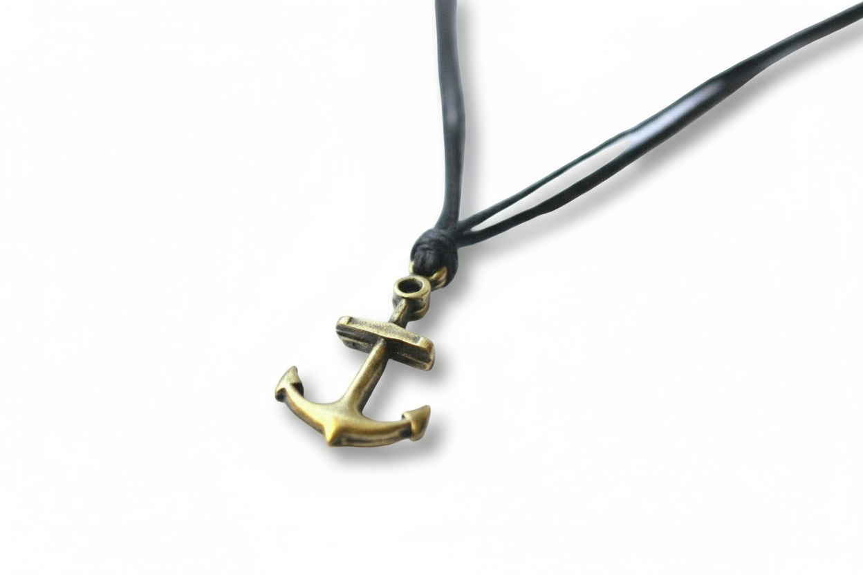 Brass anchor pendant on a black cord against a white background