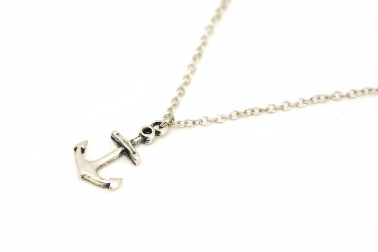 Silver anchor necklace on a white background