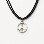 Peace symbol necklace on a black cord on a white background