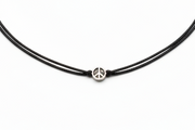 Black cord necklace with a peace sign pendant on a white background