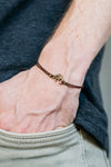 Men's bracelet with bronze Om charm, brown cord - shani-adi-jewerly