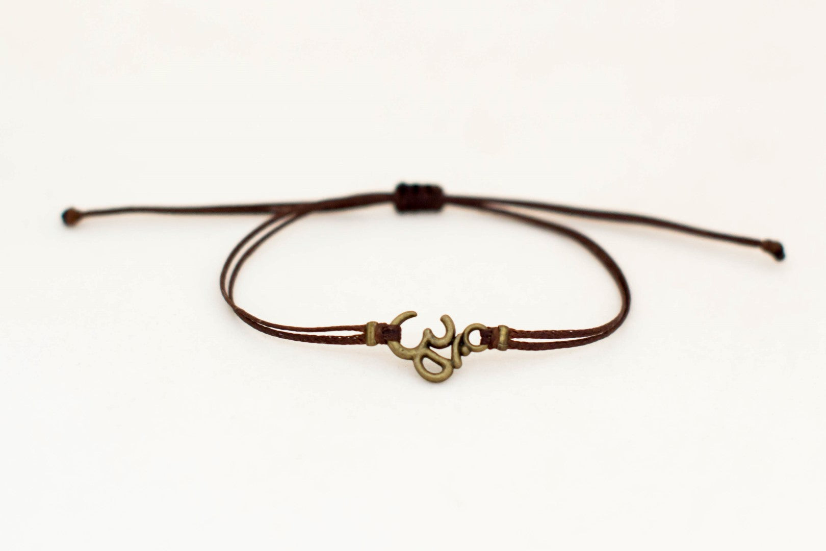 Men's bracelet with bronze Om charm, brown cord - shani-adi-jewerly