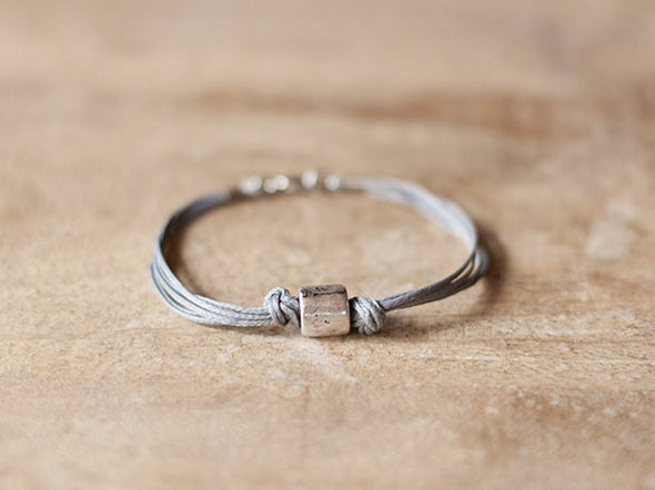 Men's bracelet with a silver tube charm and a gray cord - shani-adi-jewerly