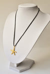 Gold sea star necklace on a black wax cord - shani-adi-jewerly