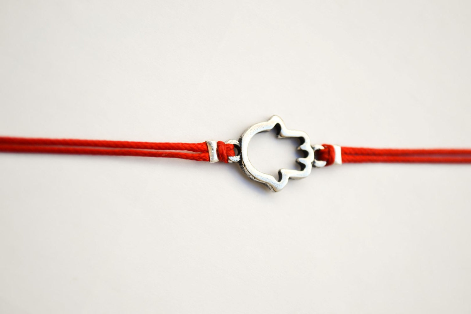 Hamsa bracelet, red wrapped bracelet with a silver Hamsa charm