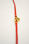 Wrapped red bracelet with gold tone Om charm - shani-adi-jewerly