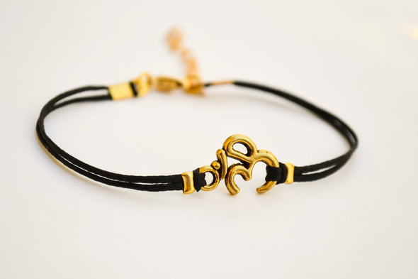 Black cord bracelet with gold tone Om charm, adjustable bracelet for her - shani-adi-jewerly