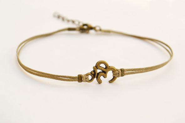 Brown cord anklet with bronze tone Om charm - shani-adi-jewerly