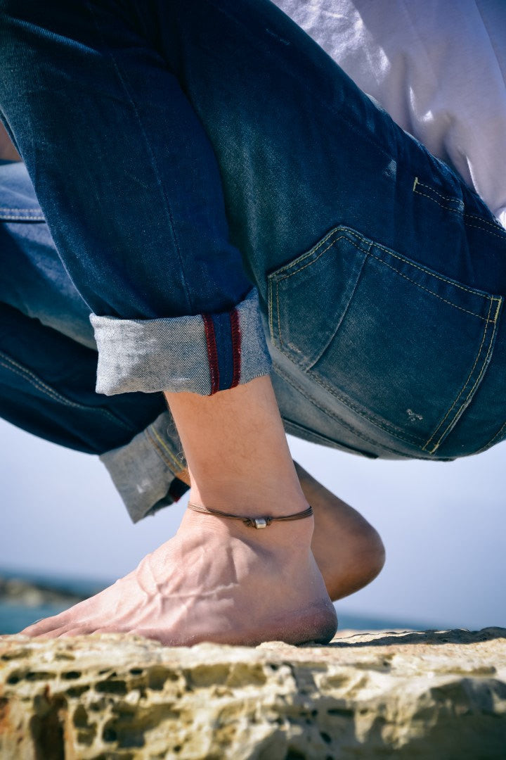 Men's anklet with a silver tube charm and a brown cord - shani-adi-jewerly