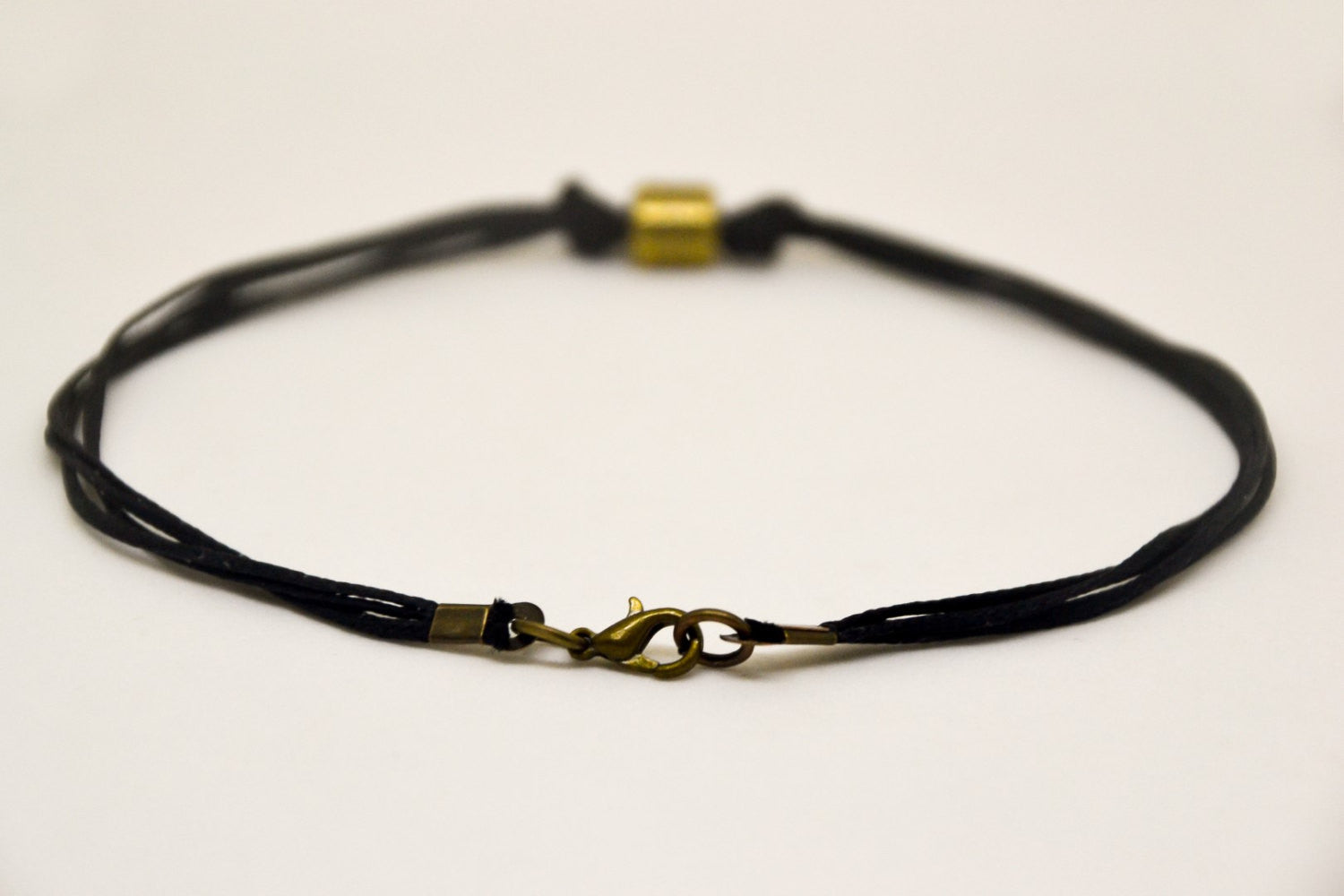 Men's anklet with a bronze tube charm and a black cord - shani-adi-jewerly