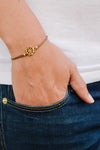 Brown cord bracelet with a 14k gold plated Ship wheel charm - shani-adi-jewerly
