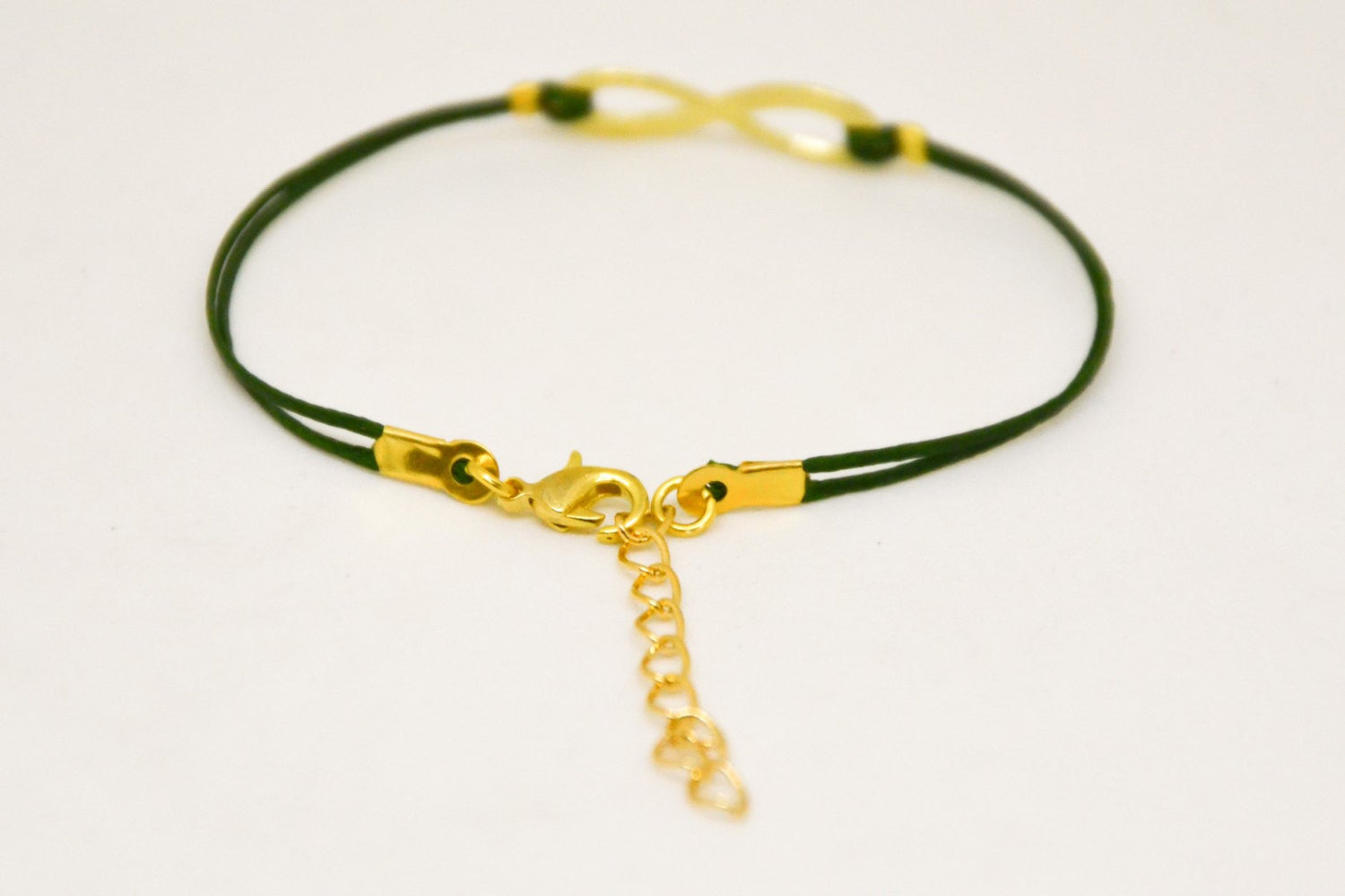 Green cord bracelet with a gold tone infinity charm - shani-adi-jewerly