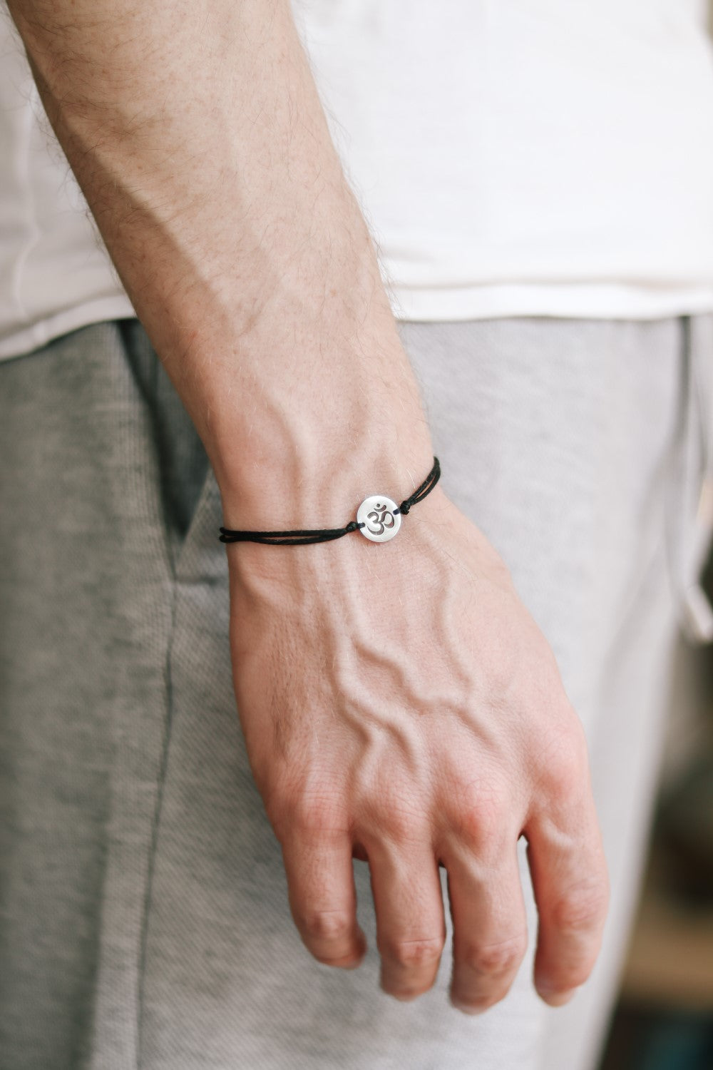 handmade silver om bracelet for men, black cord - shani and adi jewelry