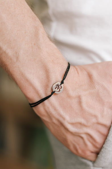 handmade silver om bracelet for men, black cord - shani and adi jewelry
